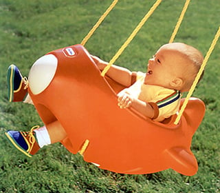 A toddler in the Little Tikes Airplane Swing